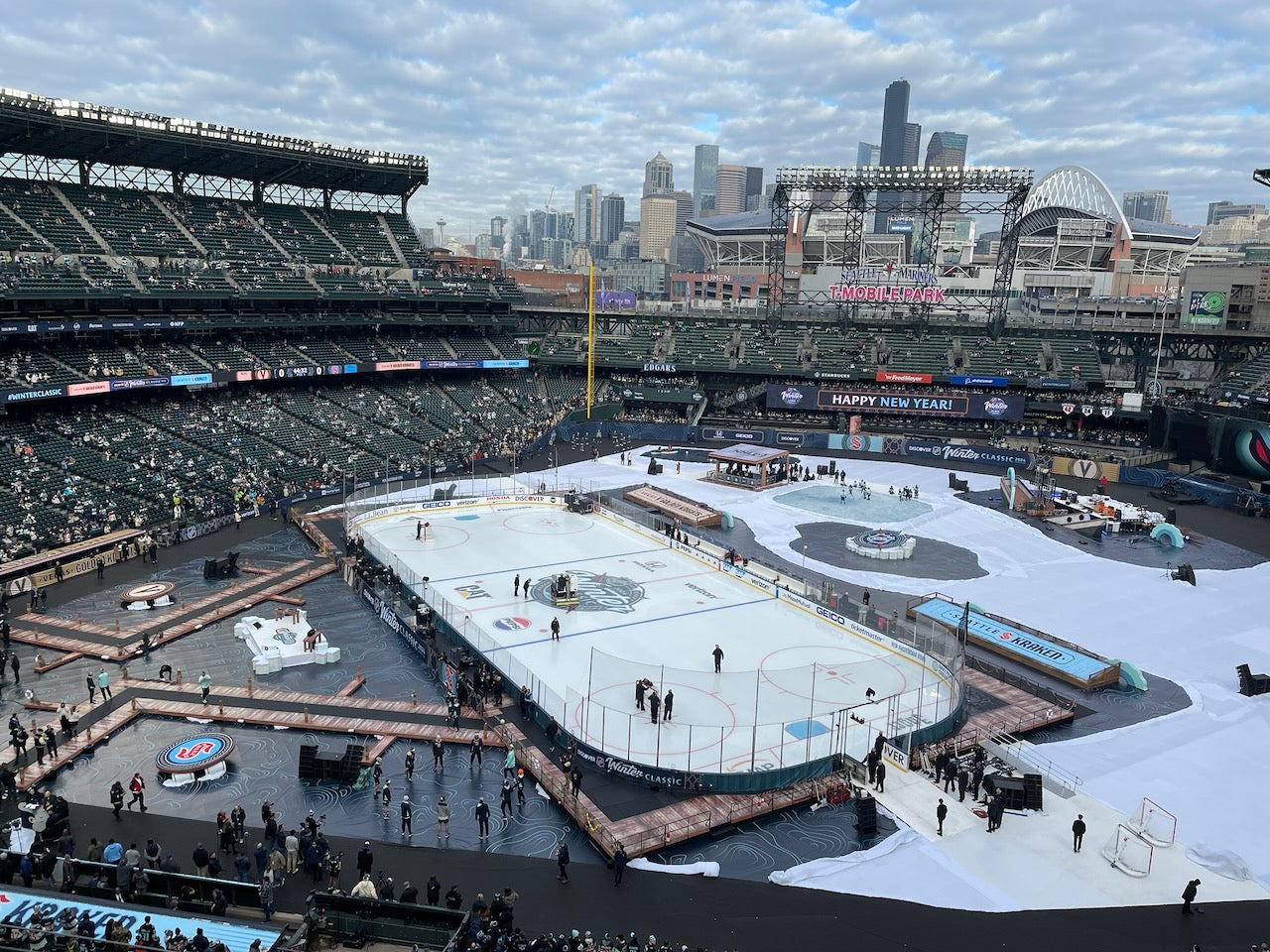 Ice rink inside a stadium with city skyline in the background