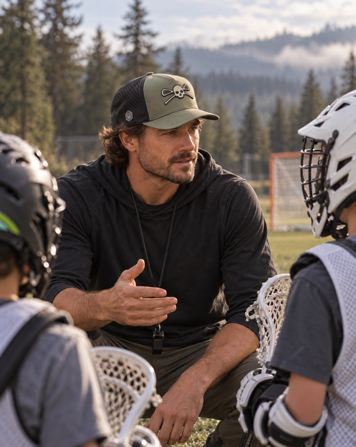 Lacrosse coach wearing the Beezlee Skull & Sticks Lacrosse Hat while talking with youth players at practice
